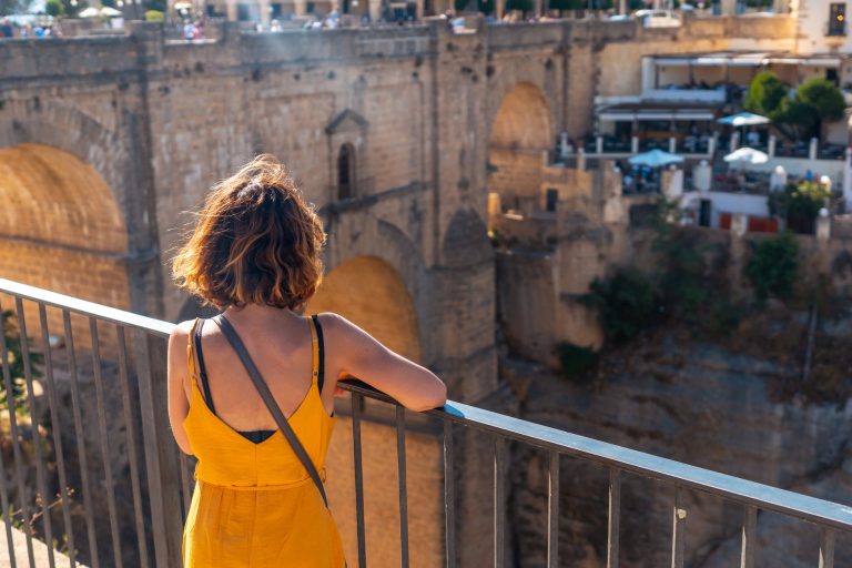 A tourist at the viewpoint visiting the new bridge in Ronda province of Malaga, Andalucia