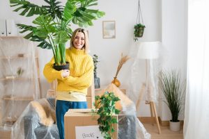 Happy woman moving to a new house