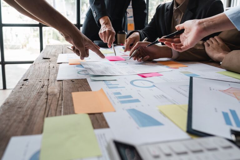 group of business people brainstorm discussing current finance and economy on company investment